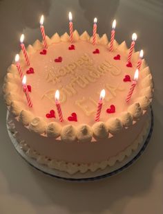 a birthday cake with lit candles on it