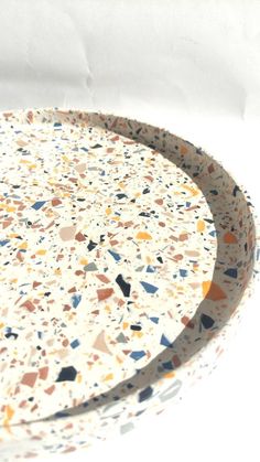 a white plate with multicolored speckles on it