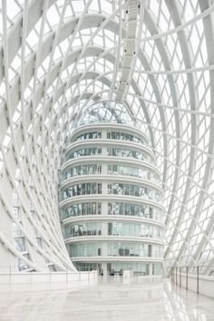 the inside of a building that has a circular structure with many windows on each side