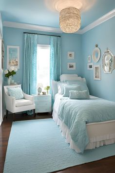 a bedroom with blue walls and white furniture