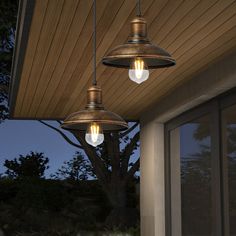 two lights are hanging from the outside of a house