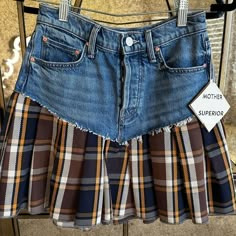 a plaid skirt hanging on a rack with a label stating mother's superfox