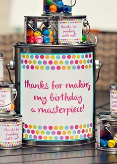 a birthday card in a tin with lots of colorful candies on the side and a sign that says thanks for making my birthday a masterpiece