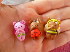 three little toy animals are in the palm of someone's hand