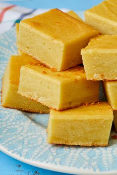 several pieces of cake sitting on top of a blue and white plate next to each other