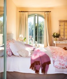 a bedroom with a large bed and sliding glass doors