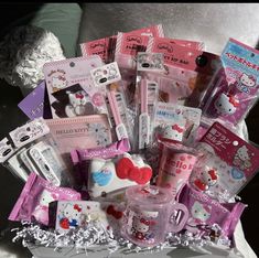 a basket filled with hello kitty items on top of a bed