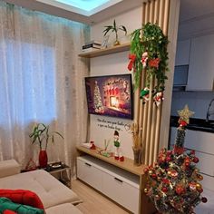 a living room decorated for christmas with decorations on the wall and tree in the corner