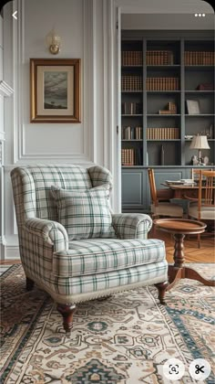 a chair sitting on top of a rug next to a book shelf filled with books