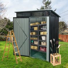 a storage shed with its doors open and shelves full of items on the grass next to a ladder