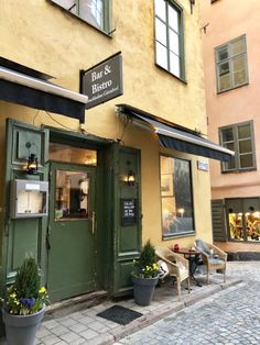 an outside view of a restaurant with potted plants