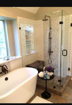 a bathroom with a tub, sink and shower in it's own area is shown