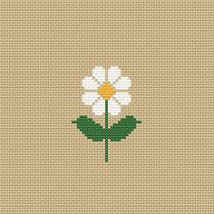 a cross stitch pattern with a white flower on the center and green leaves in the middle