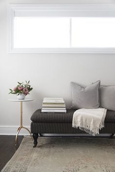 a living room with a couch, table and window