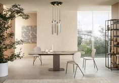 a dining room with a table and chairs next to a book shelf filled with books