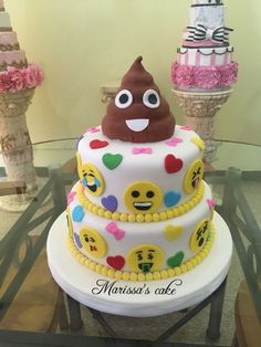 a three tiered cake decorated with emoticions and smiley faces on the top