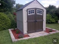 a garden shed in the middle of a yard