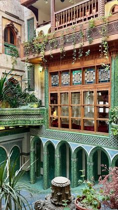 an ornate building with many windows and plants