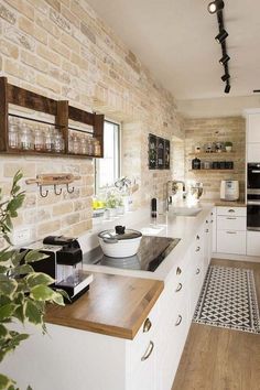 a kitchen with white cabinets and wooden counter tops