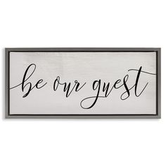 a wooden sign that says be our guest