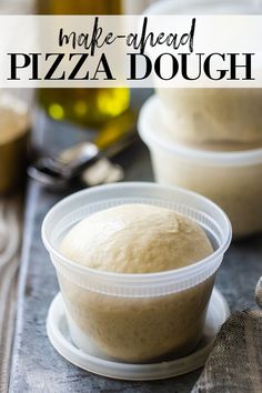 a close up of a bowl of pizza dough on a table with bread in the background