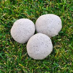 three rocks sitting in the grass with text overlay that says diy treasure stones