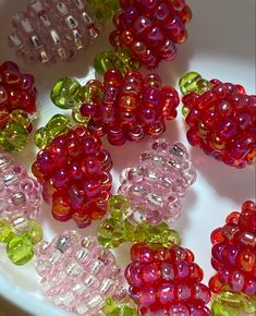 many different colored beads on a white plate