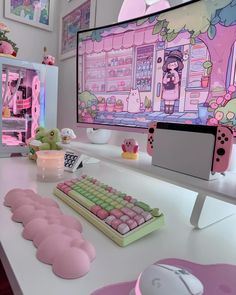 there is a computer monitor and keyboard on the desk in front of some pink decorations