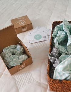 two boxes filled with donuts sitting on top of a bed