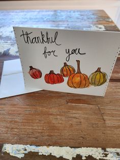 a thank you card with painted pumpkins on it