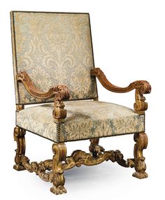 an ornately decorated chair with carved wood arms