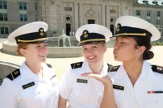 three women in naval uniforms standing next to each other