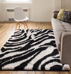 a living room with a couch, chair and rug