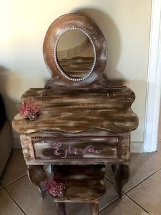 a wooden vanity with a mirror on top of it