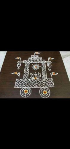 an intricately designed wooden table with white and orange designs on it