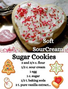 a heart shaped sugar cookie with white frosting and red sprinkles