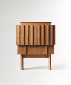 a wooden cabinet sitting on top of a white floor