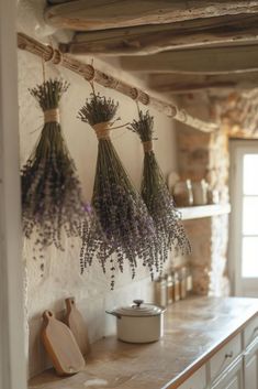 lavender flowers hanging from the ceiling in a kitchen