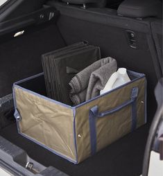 the back end of a car with an open trunk and several folded towels in it