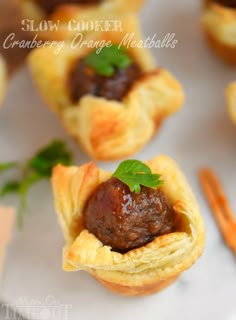 small pastries with meatballs in them on a plate