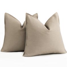 two beige pillows sitting on top of each other