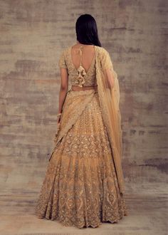 Minimalist Yet Elegant Gold Lehenga For Our Beautiful Ladies! All the women - whether they are from India or any other country have always embraced the unparalleled charm of Lehengas. Lehenga has become the preferable attire for a wedding or special occasion owing to the kind of comfort and elegance this attire provides. Keeping in mind your taste and class, Ruhani Collection have come up with this beautiful gold-coloured lehenga. Beautified with silver and gold embroidery, this lehenga is enoug Traditional Drape Sets With Cutdana For Wedding, Traditional Drape Wedding Sets With Cutdana, Wedding Sets With Cutdana In Traditional Drape, Elegant Ceremonial Lehenga With Traditional Drape, Elegant Lehenga With Dupatta For Ceremony, Elegant Traditional Drape Lehenga For Ceremony, Elegant Anarkali Set For Wedding With Traditional Drape, Elegant Choli For Ceremony With Traditional Drape, Elegant Ceremony Choli With Traditional Drape