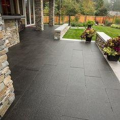 an outdoor patio with stone walls and planters