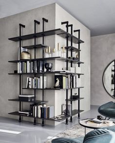 a living room filled with furniture and a book shelf next to a wall mounted mirror