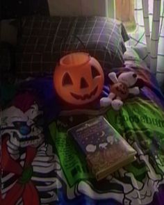 a bed with a halloween themed comforter on it