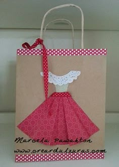 a brown paper bag with a red dress on it