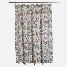 a curtain with leaves on it hanging from a rod