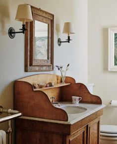 a bathroom with a sink, mirror and toilet