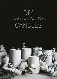 some white candles sitting on top of a table