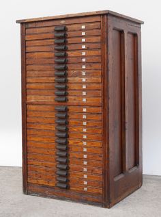 an old wooden cabinet with lots of drawers on the front and sides, made out of wood